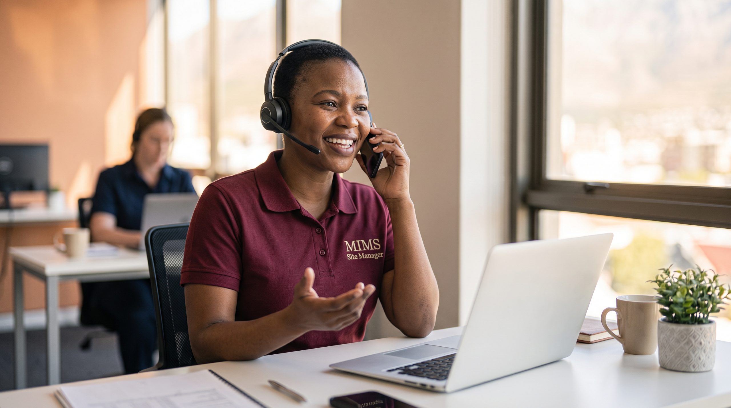 MiMs support agent wearing a headset, on a call at a laptop.